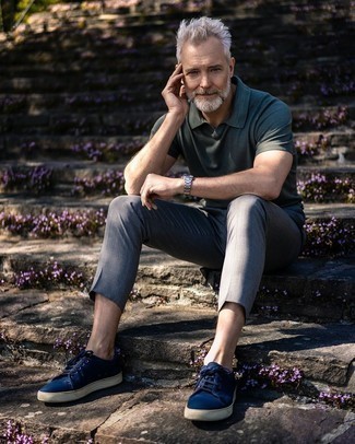 Dark Green Polo Outfits For Men: This combo of a dark green polo and grey chinos is a safe bet for a truly cool getup. Add navy canvas low top sneakers to the mix et voila, this ensemble is complete.
