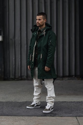 Dark Green Canvas Low Top Sneakers Outfits For Men: Pairing a dark green raincoat and white corduroy chinos will be a true indication of your expertise in menswear styling even on weekend days. Dark green canvas low top sneakers are a smart choice to finish this look.