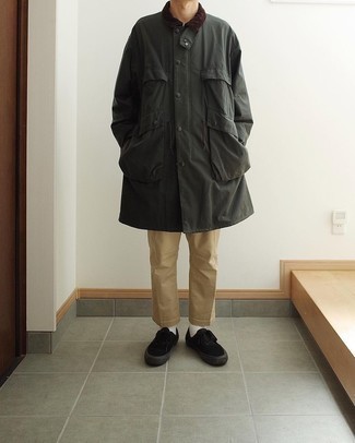 Dark Green Raincoat Outfits For Men: Make a dark green raincoat and khaki chinos your outfit choice to confidently deal with whatever this day has in store for you. If not sure about what to wear when it comes to footwear, complete your look with a pair of black canvas low top sneakers.