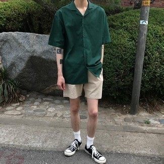 Olive Short Sleeve Shirt Outfits For Men: For an ensemble that offers practicality and fashion, rock an olive short sleeve shirt with beige shorts. The whole look comes together really well when you introduce black and white canvas low top sneakers to the mix.