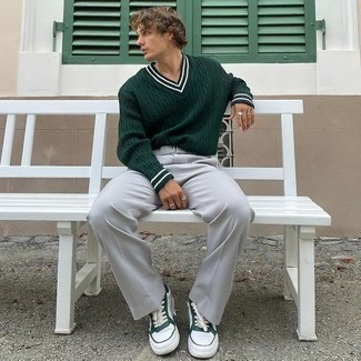 Dark Green V-neck Sweater Outfits For Men: This relaxed combination of a dark green v-neck sweater and grey chinos is perfect when you need to look neat and relaxed but have no time. Let your outfit coordination skills really shine by complementing your look with a pair of white and green leather low top sneakers.