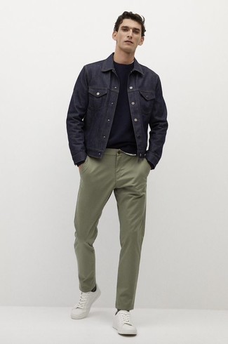 White Canvas Low Top Sneakers Outfits For Men: Combining a navy denim jacket with olive chinos is a nice option for a casual look. Give a mellow touch to your ensemble by slipping into white canvas low top sneakers.