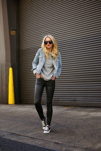 Black Leather Leggings Outfits: This pairing of a light blue denim jacket and black leather leggings is super versatile and really up for any sort of adventure you may find yourself on. If you need to immediately level up this outfit with shoes, why not complete this getup with black and white low top sneakers?