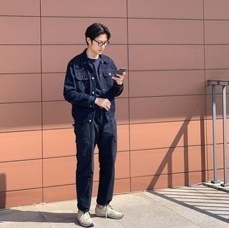 Navy Denim Jacket Outfits For Men: A navy denim jacket and navy cargo pants will inject your day-to-day wardrobe this relaxed and dapper vibe. Does this outfit feel all-too-perfect? Invite grey athletic shoes to switch things up.