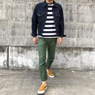 Navy Denim Jacket Outfits For Men: This casual combination of a navy denim jacket and olive chinos is extremely easy to throw together in next to no time, helping you look awesome and ready for anything without spending a ton of time combing through your wardrobe. A pair of tan canvas slip-on sneakers is a never-failing footwear style that's full of character.