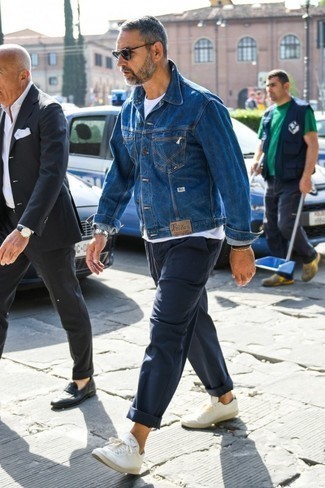 Blue Denim Jacket Outfits For Men: This outfit with a blue denim jacket and navy chinos isn't so hard to score and is easy to adapt according to circumstances. A pair of white low top sneakers easily bumps up the wow factor of your ensemble.