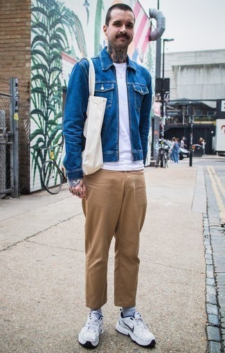 Blue Denim Jacket Outfits For Men: This laid-back combo of a blue denim jacket and khaki chinos is ideal if you want to go about your day with confidence in your look. Finishing off with white athletic shoes is a fail-safe way to add a touch of stylish effortlessness to your look.