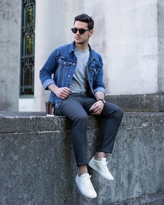 Grey Vertical Striped Chinos Outfits: Pair a blue denim jacket with grey vertical striped chinos to assemble an interesting and modern-looking casual ensemble. The whole ensemble comes together if you complement your outfit with a pair of white canvas low top sneakers.