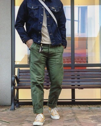 Yellow Low Top Sneakers Outfits For Men: This casual pairing of a navy denim jacket and olive chinos is very easy to pull together in no time flat, helping you look amazing and prepared for anything without spending too much time digging through your wardrobe. Rev up the fashion factor of this outfit by slipping into yellow low top sneakers.