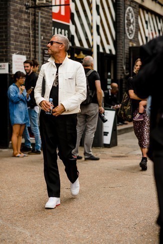 Black Leather Zip Pouch Outfits For Men: Try teaming a white denim jacket with a black leather zip pouch to feel completely confident in yourself and look sharp. A cool pair of white leather low top sneakers is the simplest way to inject a touch of elegance into your ensemble.