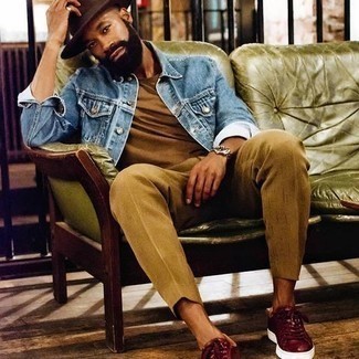 Red Leather Low Top Sneakers Outfits For Men: This combination of a blue denim jacket and khaki dress pants is a goofproof option when you need to look truly sharp and classy. Go ahead and complete this look with a pair of red leather low top sneakers for a touch of stylish casualness.