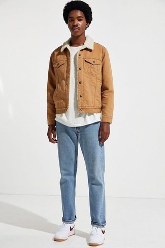 Tan Denim Jacket Outfits For Men: A tan denim jacket and light blue jeans are a savvy combination to have in your off-duty rotation. Let your styling skills really shine by finishing this look with a pair of white leather low top sneakers.