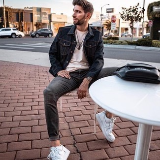 Charcoal Jeans Outfits For Men: This relaxed combination of a navy denim jacket and charcoal jeans is super easy to pull together without a second thought, helping you look amazing and prepared for anything without spending too much time searching through your closet. Look at how nice this outfit is complemented with white leather low top sneakers.