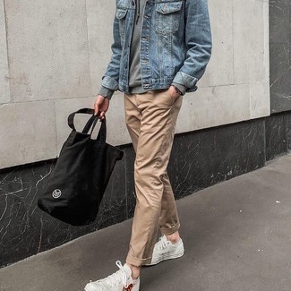 Denim Jacket Outfits For Men: Super stylish and functional, this casual combo of a denim jacket and khaki chinos brings variety. Finishing with white print canvas low top sneakers is the most effective way to introduce a more relaxed touch to your outfit.