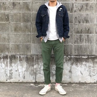 500+ Fall Outfits For Men: This pairing of a navy denim jacket and olive chinos is great for most casual occasions. White canvas low top sneakers will add a more casual twist to an otherwise mostly classic ensemble. It's is a smart choice when it comes to a comfortable transition look.