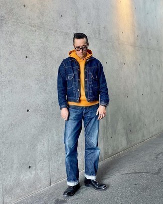 Orange Hoodie Outfits For Men: You'll be amazed at how easy it is for any gent to pull together this laid-back look. Just an orange hoodie and navy jeans. Not sure how to round off this outfit? Finish with a pair of black leather derby shoes to bump it up.