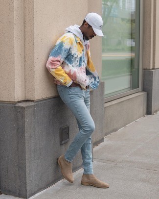 White Tie-Dye Denim Jacket Outfits For Men: A white tie-dye denim jacket and light blue skinny jeans will add serious dapperness to your casual rotation. To give your look a smarter twist, introduce a pair of tan suede chelsea boots to the equation.
