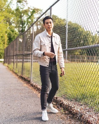 White and Red Canvas High Top Sneakers Outfits For Men: When the setting permits off-duty styling, you can dress in a beige denim jacket and charcoal jeans. To inject a mellow feel into this look, add a pair of white and red canvas high top sneakers to your look.