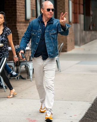 If you enjoy the comfort look, consider wearing a blue denim jacket and beige jeans. You can get a bit experimental with footwear and tone down your outfit with a pair of tobacco athletic shoes.