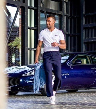 Polo Outfits For Men: For a casual and cool ensemble, consider wearing a polo and navy chinos — these two pieces fit really good together. Enter a pair of white leather low top sneakers into the equation and you're all done and looking spectacular.