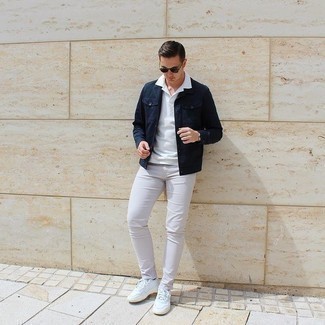 White Sneakers with Beige Jeans Casual Summer Outfits For Men: For a casual outfit, consider pairing a navy denim jacket with beige jeans — these two items fit really well together. Break up your ensemble by rounding off with white sneakers. There are a ton of ways to look neat and survive the heatwave, and this here is one of them.