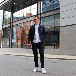 White Low Top Sneakers with Denim Jacket Outfits For Men: This combination of a denim jacket and navy chinos looks pulled together and instantly makes you look cool. Got bored with this look? Enter a pair of white low top sneakers to jazz things up.