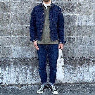 Men's Outfits 2021: A navy denim jacket and navy jeans are a cool combo to have in your casual collection. A pair of black and white canvas low top sneakers will tie the whole thing together.