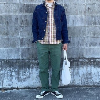 Men's Outfits 2021: A navy denim jacket and dark green chinos are among the key elements in any modern gent's versatile off-duty closet. Does this outfit feel too classic? Enter black and white canvas low top sneakers to shake things up.