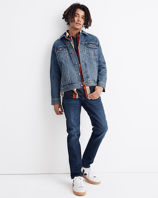 Blue Denim Jacket Outfits For Men: A blue denim jacket and navy jeans are a smart combo worth integrating into your current lineup. If in doubt about what to wear in the shoe department, go with white and black leather low top sneakers.