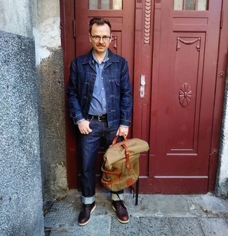 Beige Canvas Backpack Outfits For Men: The pairing of a navy denim jacket and a beige canvas backpack makes for a solid laid-back ensemble. Let's make a bit more effort now and complete your look with dark brown leather desert boots.