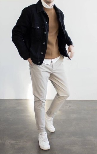 Black Denim Jacket Outfits For Men: You'll be amazed at how extremely easy it is for any guy to pull together this relaxed ensemble. Just a black denim jacket and grey chinos. To infuse a laid-back touch into your outfit, complete this getup with a pair of white leather low top sneakers.