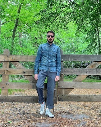 Blue Denim Shirt Outfits For Men: A blue denim shirt and navy chinos are essential in any modern man's great casual sartorial arsenal. Introduce white canvas high top sneakers to the mix to keep the outfit fresh.
