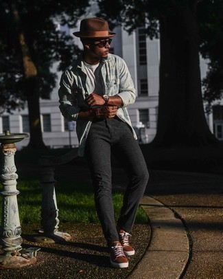 Brown Leather Low Top Sneakers Outfits For Men: In situations comfort is the priority, this combo of a light blue tie-dye denim shirt and charcoal check chinos is a no-brainer. If you're on the fence about how to finish off, add a pair of brown leather low top sneakers to the mix.