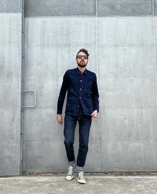 Black Sunglasses Casual Outfits For Men: Opt for a navy denim shirt and black sunglasses if you wish to look casually stylish without trying too hard. Complement your getup with a pair of navy and white canvas low top sneakers for an extra dose of polish.