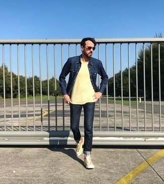 Yellow Crew-neck T-shirt Outfits For Men: For a casual ensemble, pair a yellow crew-neck t-shirt with navy jeans — these pieces work really well together. Feel uninspired with this outfit? Let a pair of multi colored canvas high top sneakers spice things up.