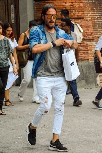Navy Denim Shirt Outfits For Men: If you prefer city casual pairings, then you'll love this combo of a navy denim shirt and white ripped jeans. Add black and white athletic shoes to this outfit to make a dressy getup feel suddenly fresh.