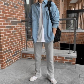 Light Blue Denim Shirt Outfits For Men: A light blue denim shirt and grey sweatpants are a great ensemble to incorporate into your day-to-day repertoire. White canvas low top sneakers pull the getup together.
