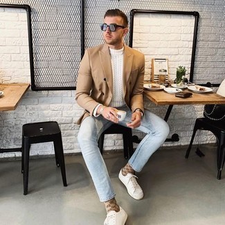 White Cable Sweater Outfits For Men: This combination of a white cable sweater and light blue jeans is hard proof that a safe casual look doesn't have to be boring. White canvas low top sneakers will be the perfect accompaniment to this look.