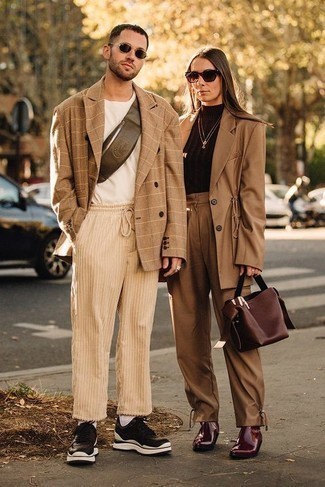Fanny Pack Outfits For Men: This combination of a tan check double breasted blazer and a fanny pack is undeniable proof that a simple casual getup doesn't have to be boring. Let your styling expertise truly shine by finishing off your outfit with a pair of black and white leather low top sneakers.