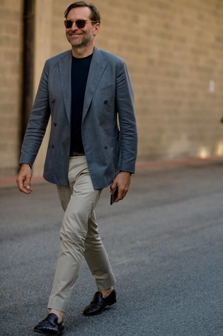 Black Woven Leather Loafers Outfits For Men: Marry a navy double breasted blazer with grey chinos to put together an interesting and modern-looking outfit. Finish your look with black woven leather loafers to change things up a bit.