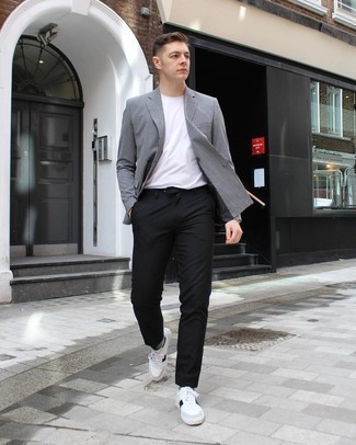 White and Black Houndstooth Blazer Outfits For Men: This look proves it is totally worth investing in such menswear essentials as a white and black houndstooth blazer and black chinos. On the shoe front, go for something on the laid-back end of the spectrum and complement your look with a pair of white and black leather low top sneakers.