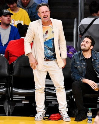 David Arquette wearing Beige Double Breasted Blazer, Multi colored Print Crew-neck T-shirt, Beige Jeans, White Print Canvas Low Top Sneakers