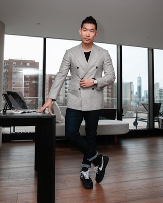 Grey Double Breasted Blazer Outfits For Men: Pairing a grey double breasted blazer and navy jeans is a fail-safe way to inject your styling routine with some masculine refinement. Does this look feel all-too-classic? Let black and white canvas low top sneakers shake things up.