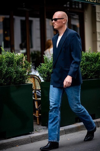 Blue Jeans Outfits For Men: Combining a navy double breasted blazer and blue jeans is a guaranteed way to inject masculine elegance into your styling arsenal. If you want to feel a bit fancier now, complete your ensemble with black leather chelsea boots.