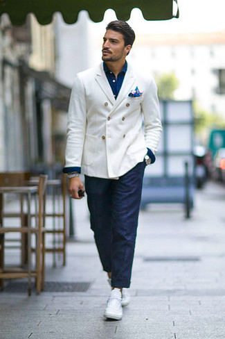 White Double Breasted Blazer Outfits For Men: This combination of a white double breasted blazer and navy chinos lies somewhere between dressy and casual. To infuse a fun vibe into your getup, introduce a pair of white low top sneakers to the equation.