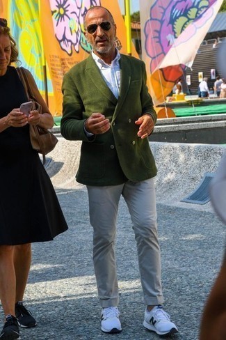 Dark Green Double Breasted Blazer Outfits For Men: This combo of a dark green double breasted blazer and beige chinos falls somewhere between classic and casual. Dial down the classiness of this ensemble by sporting a pair of white and black athletic shoes.