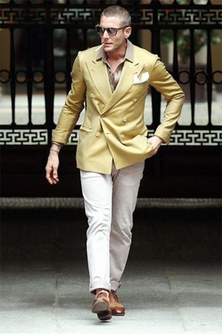 Mustard Double Breasted Blazer Outfits For Men: You'll be amazed at how easy it is for any gentleman to pull together this effortlessly sleek look. Just a mustard double breasted blazer and white chinos. Serve a little outfit-mixing magic by finishing with brown leather oxford shoes.