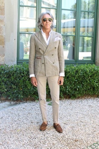 Beige Double Breasted Blazer Outfits For Men: This look with a beige double breasted blazer and beige chinos isn't hard to pull off and easy to adapt. Rev up this whole ensemble by finishing with a pair of brown suede loafers.