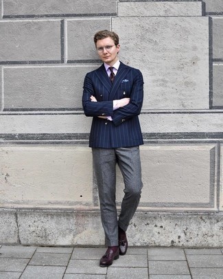 Charcoal Wool Dress Pants Outfits For Men: Pair a navy vertical striped double breasted blazer with charcoal wool dress pants to look like a perfect gent at all times. Bump up the fashion factor of this look by rounding off with burgundy leather tassel loafers.