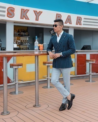 Navy Vertical Striped Double Breasted Blazer Outfits For Men: Opt for a navy vertical striped double breasted blazer and a white dress shirt for a sharp and polished silhouette. This getup is finished off wonderfully with black leather tassel loafers.